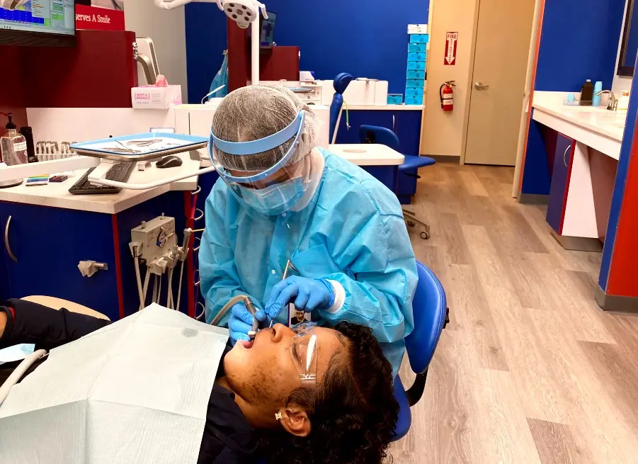 diamondbraces Orthodontist Working With Teen Patient