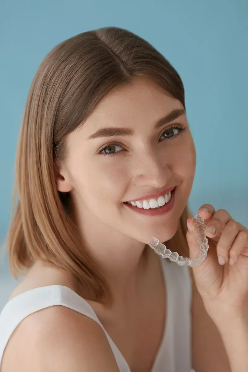 diamondbraces Woman Holding her Invisalign Aligner